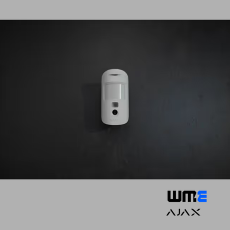 white Ajax motion detector on a dark wall