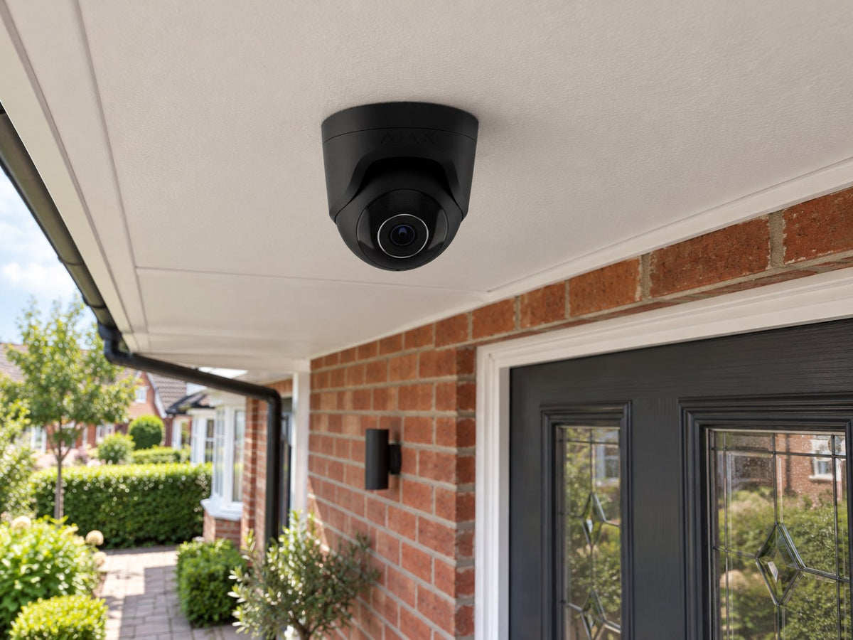 Ajax TurretCam • 5MP 4mm • Black installed in British red-brick home entrance porch, front door and small garden beyond.