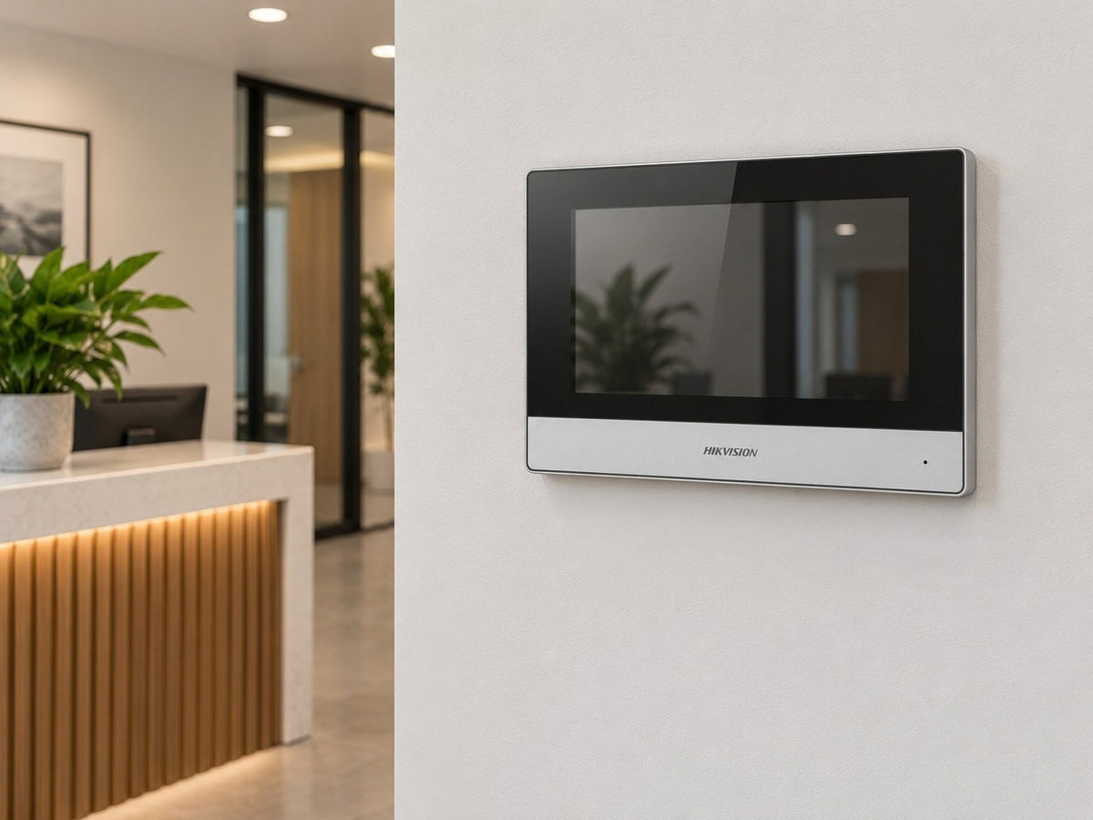Hikvision DS-KH6320Y-WTE2 shown at a reception-area wall.
