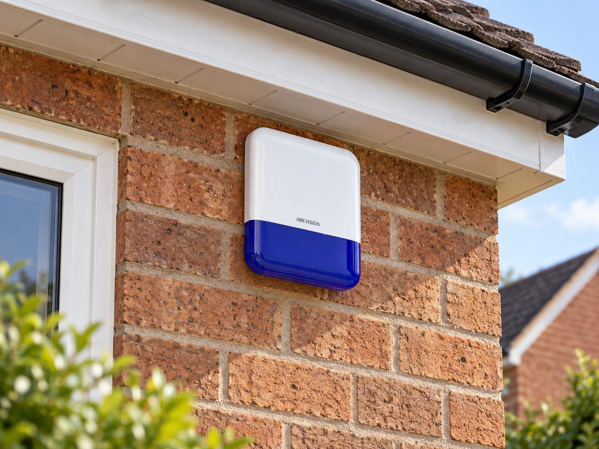 Hikvision DS-PS1-E-WE •Blue installed in brick house facade high beneath eaves.