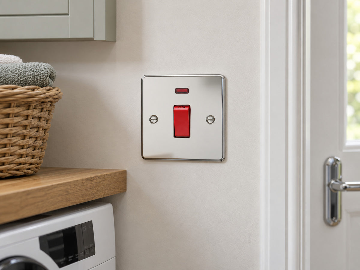 Knightsbridge FP8331NPC polished chrome double-pole switch installed in a dry UK utility-room wall beside a cupboard.
