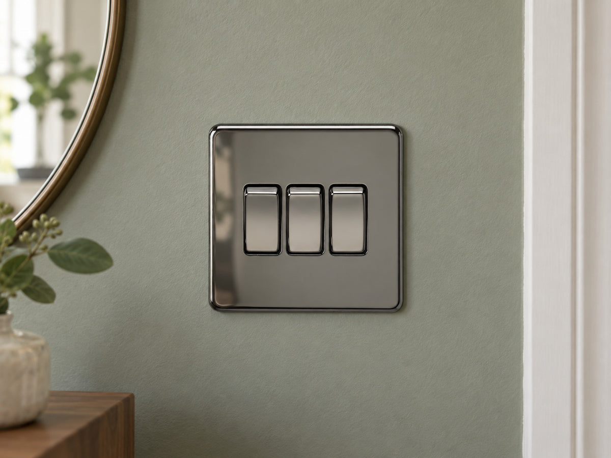 Knightsbridge SF4000BN black nickel light switch fitted on a UK living-room entrance wall with muted sage paint.