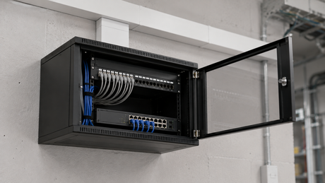 Compact 4U wall-mounted 19 inch comms cabinet with glass door open showing a patch panel and network switch