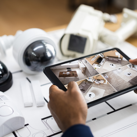 Man using a tablet to connect CCTV cameras