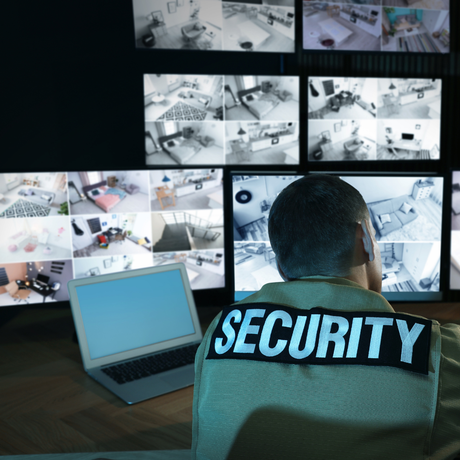 Security guard watching CCTV camera for a business