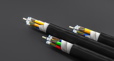 Fiber optic cables transmitting data with luminous ends on dark background