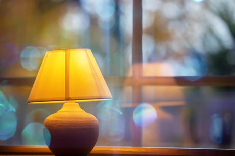 Yellow lamp against window 