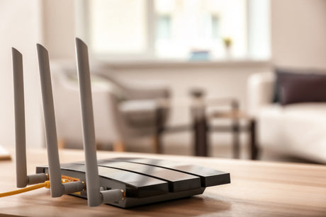 Modern wi-fi router on wooden table