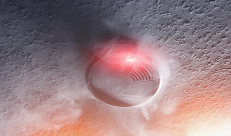Smoke detector with white smoke and red warning light