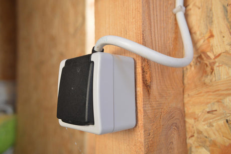 outdoor, weatherproof socket on a wooden wall 