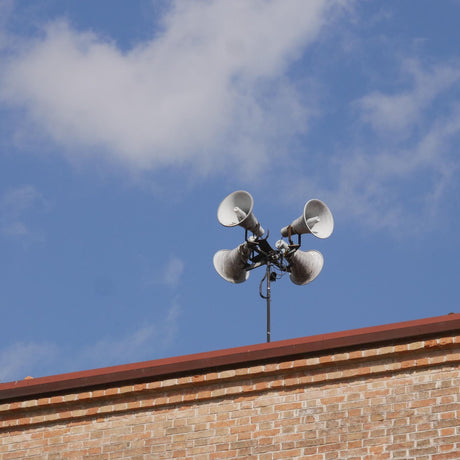 PA speakers against blue sky 