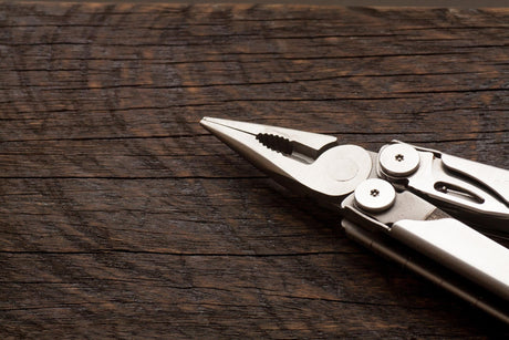 High angle view of pliers on wooden table