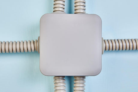 White unction box on pale blue wall