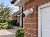 Ajax BulletCam 79028.217.WH1 installed in British red-brick home driveway.