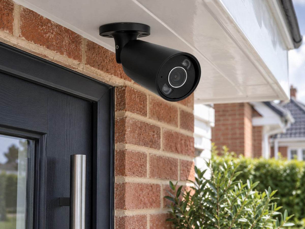 Ajax BulletCam HL in a British brick home entrance under a white soffit.