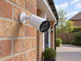 Ajax BulletCam HL • 5MP 2.8mm • White installed in pale-brick British house driveway.