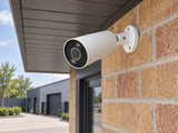Ajax BulletCam HL • 5MP 4mm • White installed in modern British light-industrial entrance.