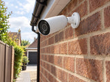 Ajax BulletCam HL • 8MP 2.8mm • White installed in British detached-home side passage.