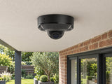 Ajax DomeCam Mini HL • 5MP 2.8mm • Black installed in British home covered rear patio, brick facade and planting below.