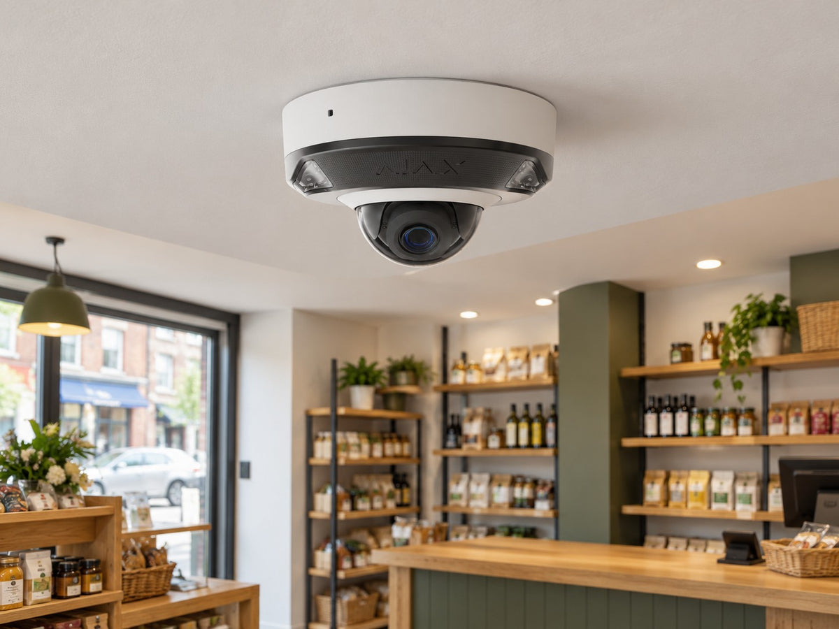 Ajax DomeCam Mini HL • 5MP 2.8mm • White installed in neat British independent shop interior.