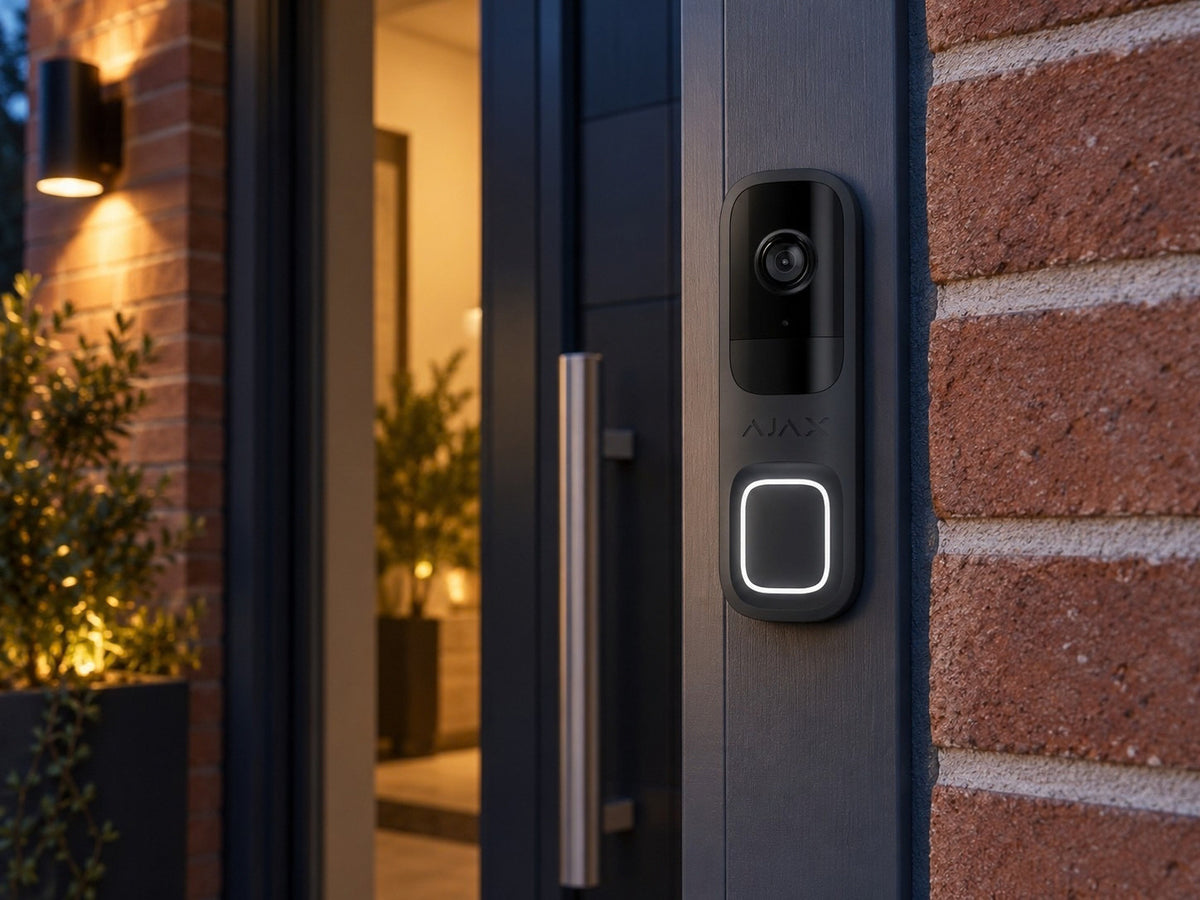 Ajax DoorBell Graphite shown at a brick entrance.