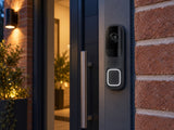 Ajax DoorBell Graphite shown at a brick entrance.