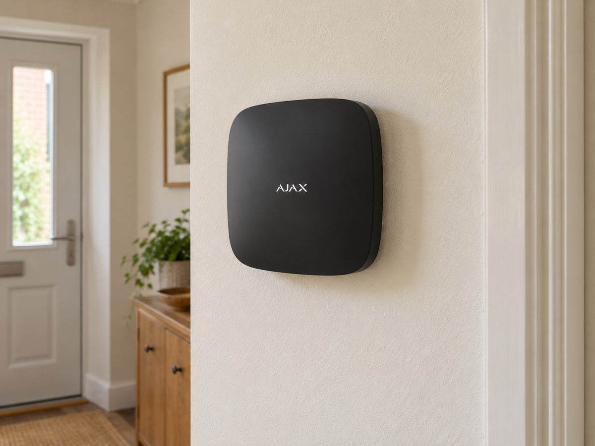 Ajax Hub 2 Plus • Black installed in calm British home utility hallway.