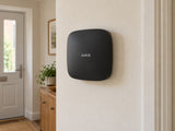 Ajax Hub 2 Plus • Black installed in calm British home utility hallway.