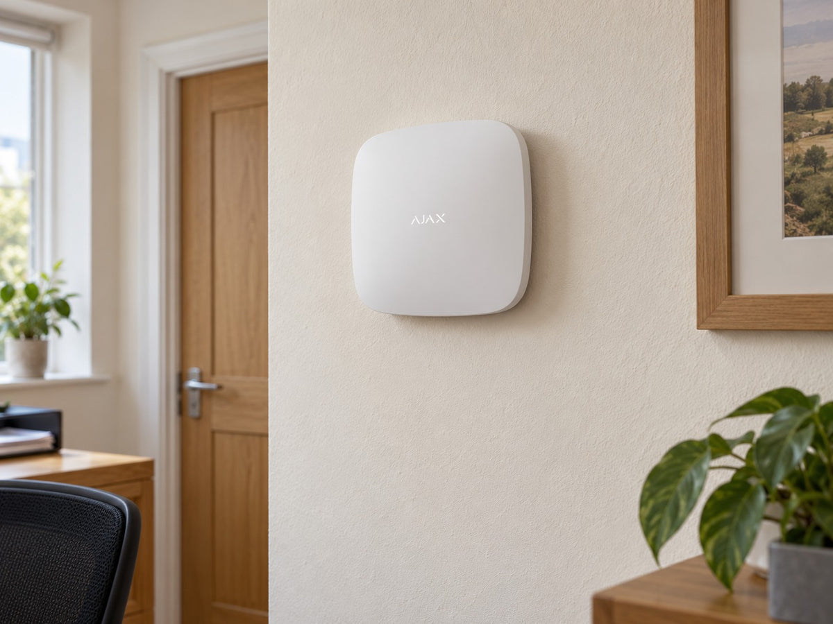 Ajax Hub 2 Plus • White installed in small British office administration room.