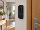 Ajax KeyPad TouchScreen • White installed in British hallway beside an oak door.