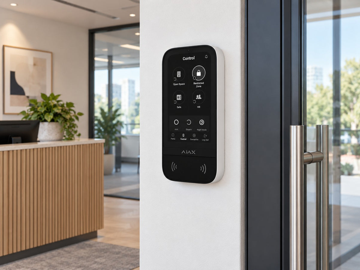 Ajax KeyPad TouchScreen • White installed in office reception beside glazed doorway.