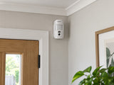 Ajax MotionCam Fibra white mounted upright above a home-office entrance.