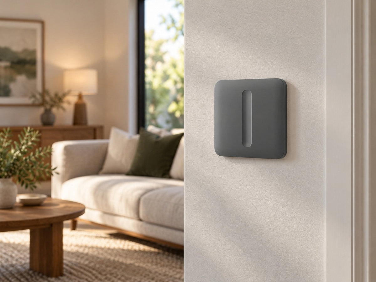Ajax SoloButton Dimmer Grey shown at a living-room wall.