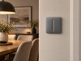 Ajax SoloButton Dimmer Grey shown at a dining-room wall.