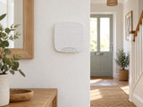 Ajax Superior HomeSiren installed in bright home hallway.