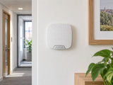 Ajax Superior HomeSiren installed in small office corridor.