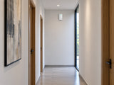 Ajax Superior MotionProtect G3 Fibra high on a corridor end wall.