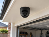 Ajax TurretCam • 8MP 2.8mm • Black installed in British home garage entrance beneath a flat cream soffit.