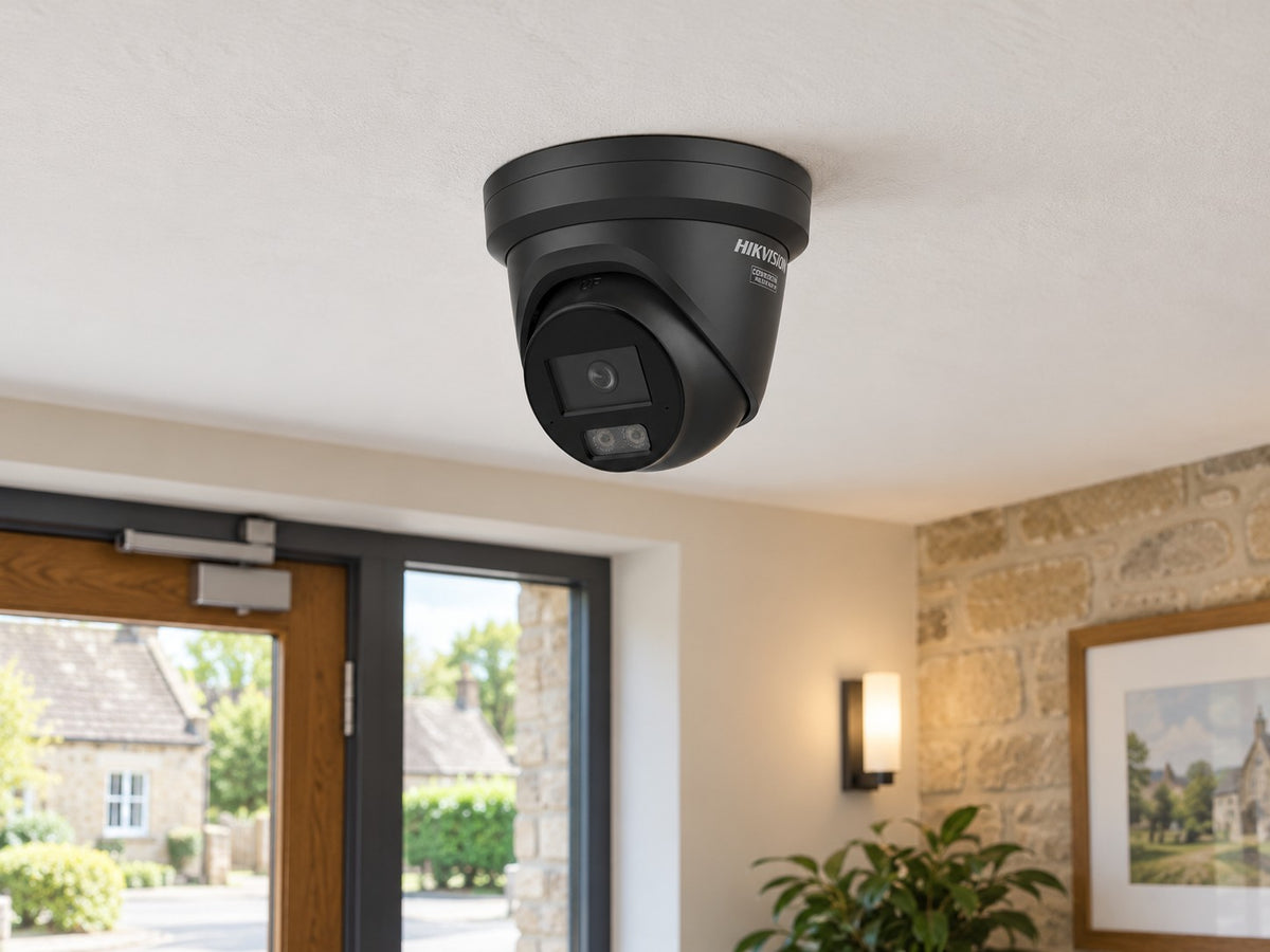 Hikvision DS-2CD2346G3-IZS2UY/SL (black) installed in British village business entrance hall.