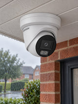 Hikvision DS-2CD2387G3-LI2UY under a rainy porch.