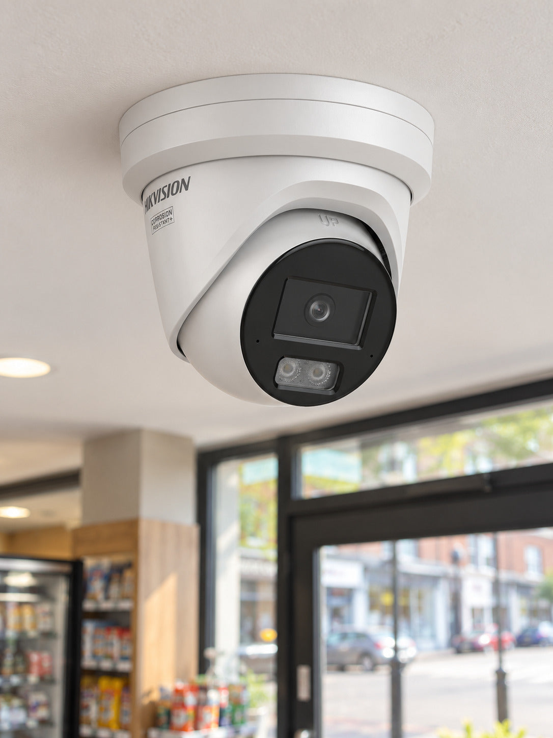 Hikvision DS-2CD2387G3-LI2UY at a shop entrance.