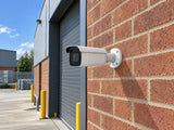Hikvision DS-2CD2643G2-IZS installed in British business loading courtyard.