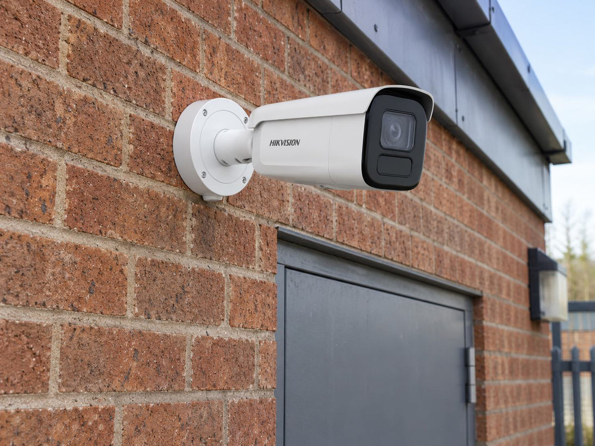 Hikvision DS-2CD2646G2H-IZS installed in British independent shop service entrance.
