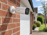 Hikvision DS-2CD2646G2H-IZS installed in British red-brick home driveway.