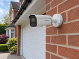 Hikvision DS-2CD2666G2H-IZS installed in British red-brick home driveway.