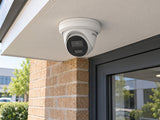 Hikvision DS-2CD3346G2-ISU white mounted beneath an office entrance canopy.