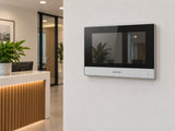 Hikvision DS-KH6320Y-WTE2 shown at a reception-area wall.