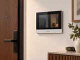 Hikvision DS-KH6320Y-WTE2 shown at a wall beside a door.