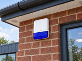 Hikvision DS-PS1-E-WE •Blue installed in brick commercial unit facade high beside upper window.