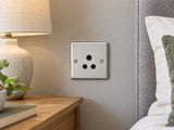 Knightsbridge CL5ABC brushed chrome lighting socket installed in a dry UK bedroom wall near an unconnected bedside lamp.